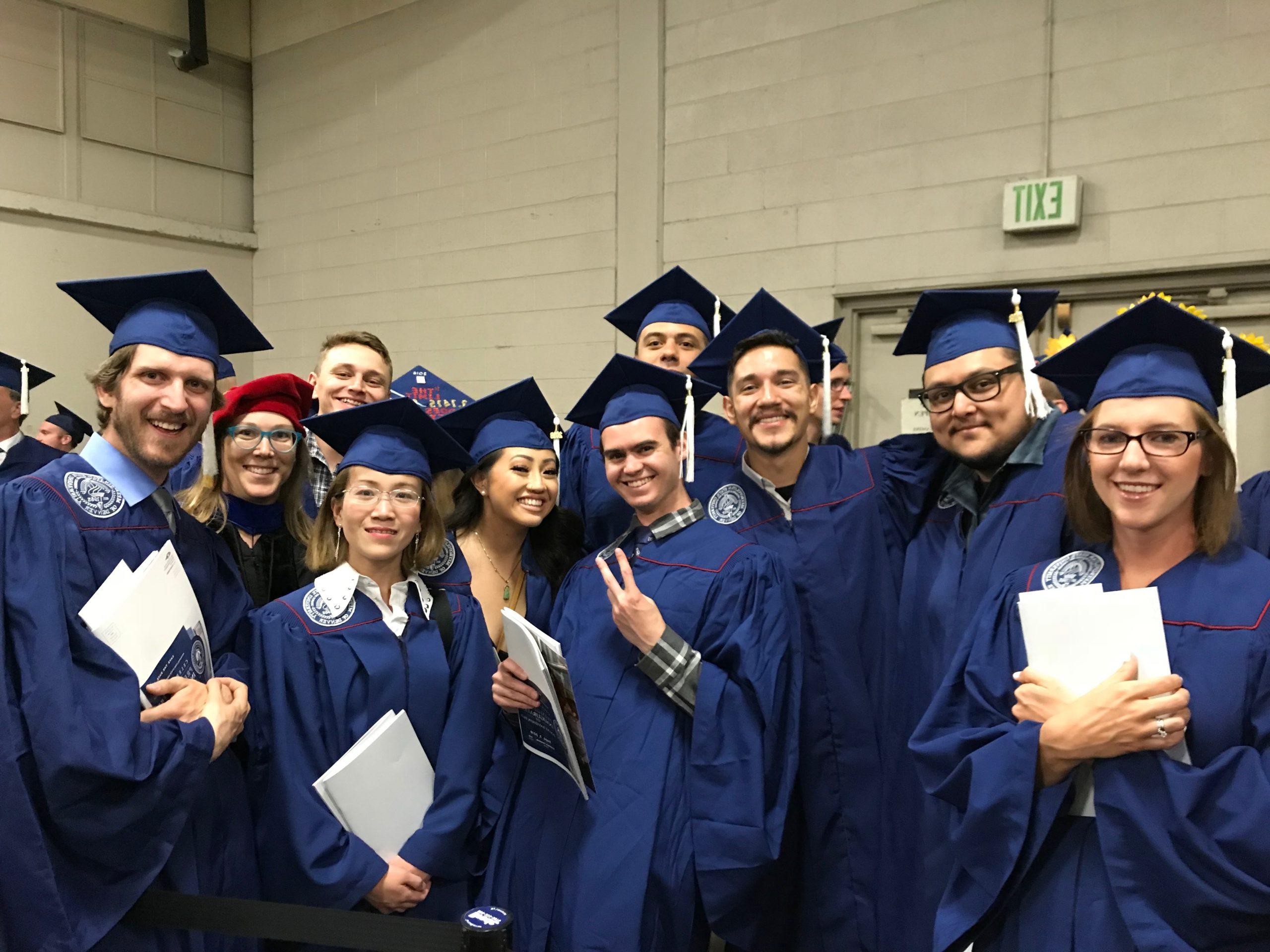 Collection of math & stats faculty in graduation caps and gowns