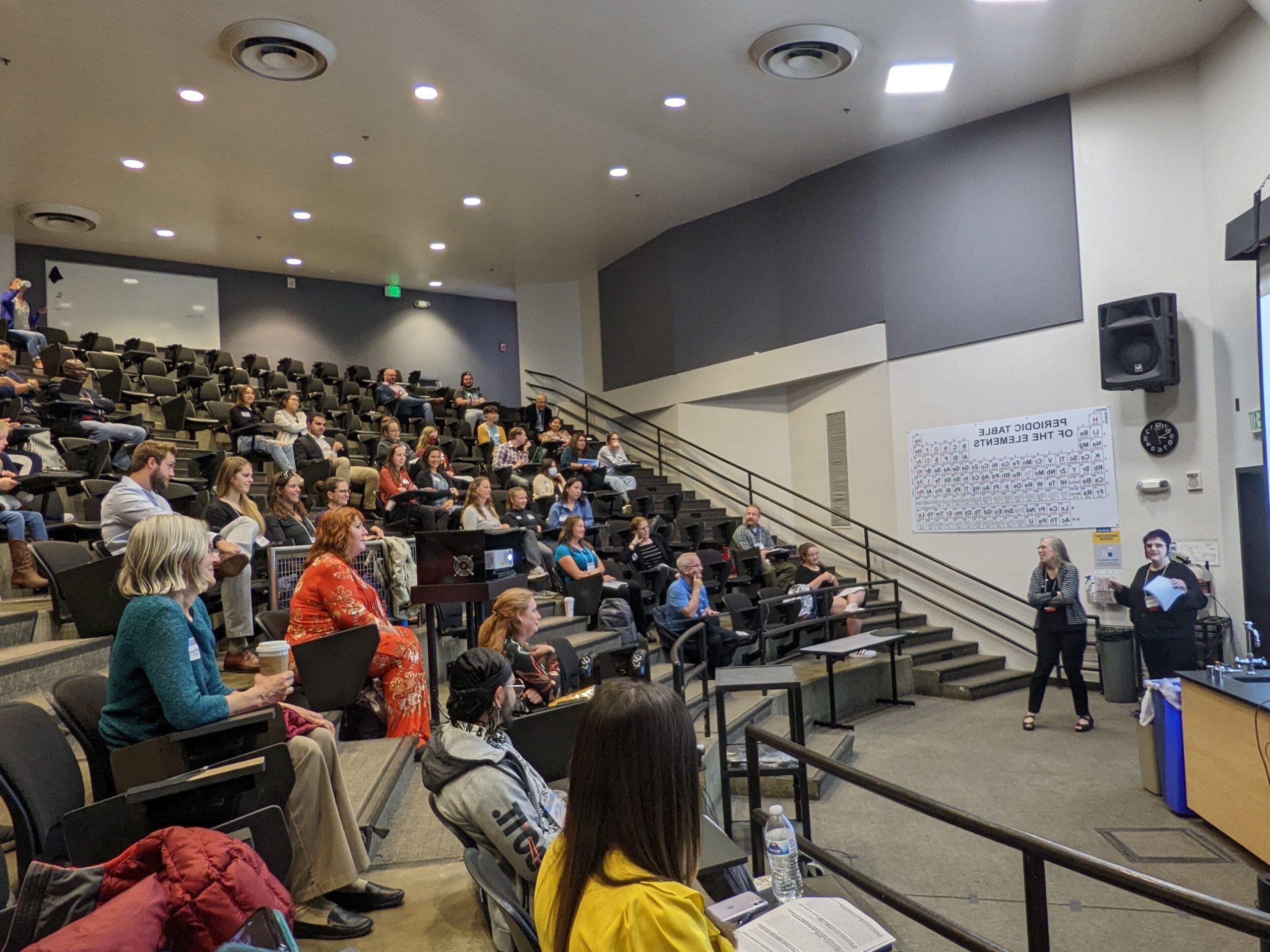 Image of a large stadium classroom with an instructor at the front