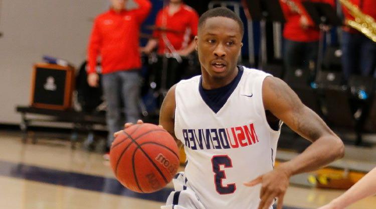 MSU Denver basketball player dribbles towards the hoop