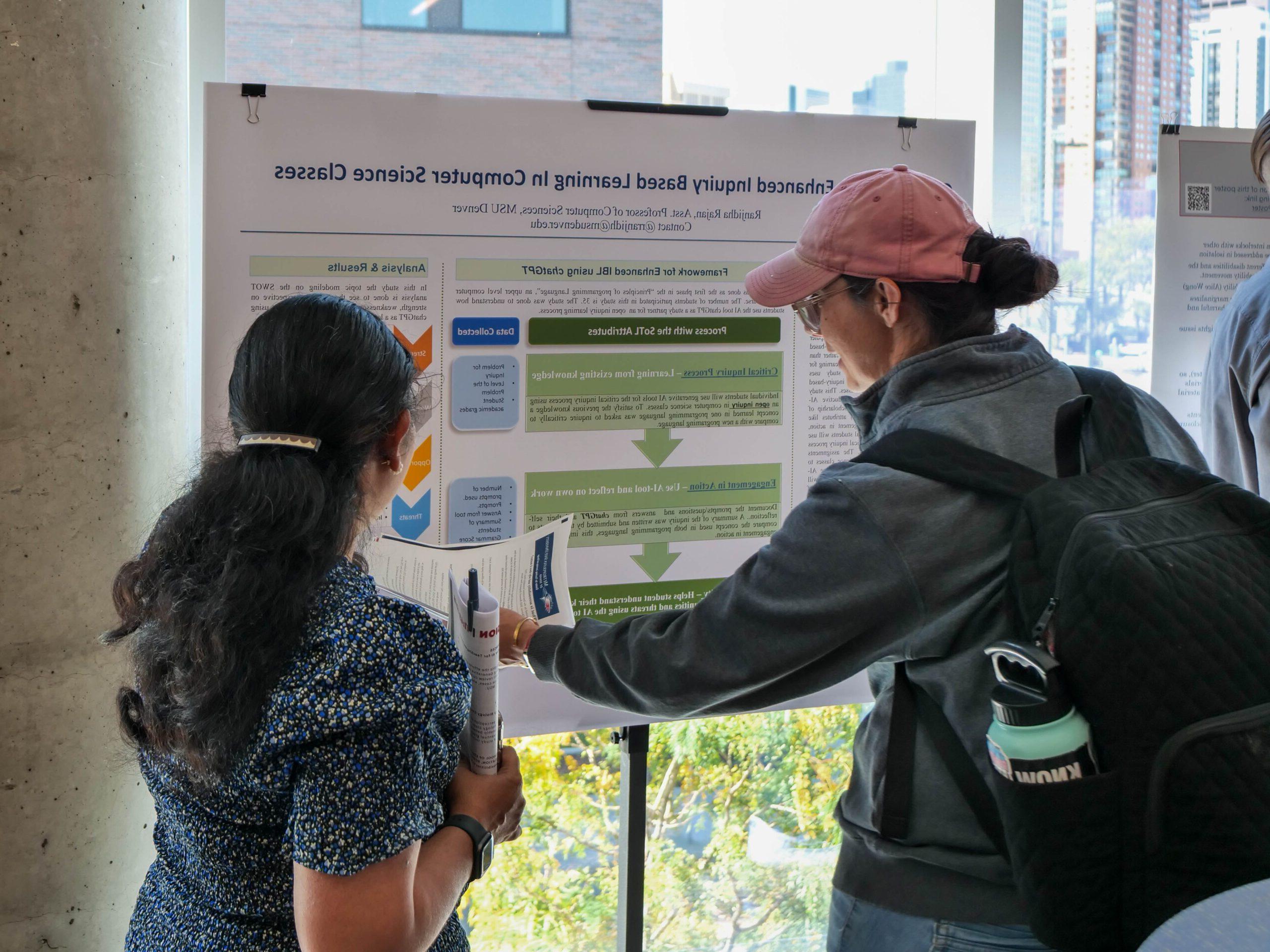 Faculty and staff discussing research projects at the SoTL poster session