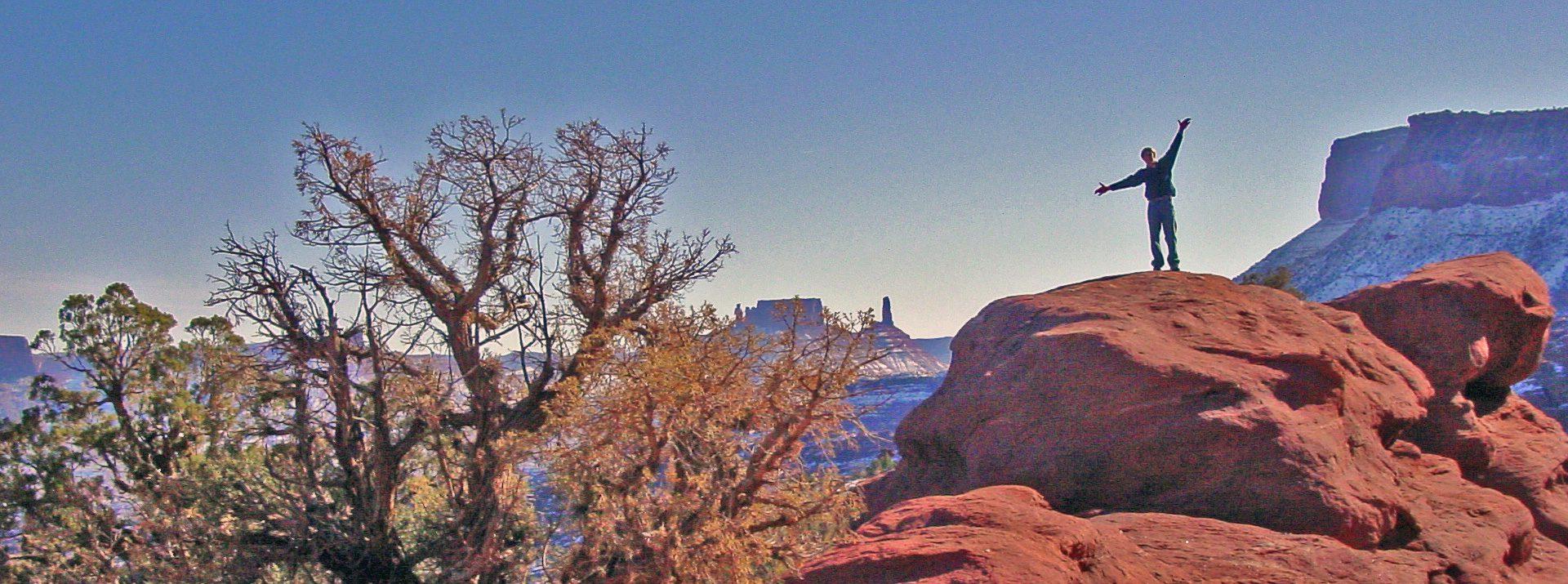 Man with outstretched arms in canyon