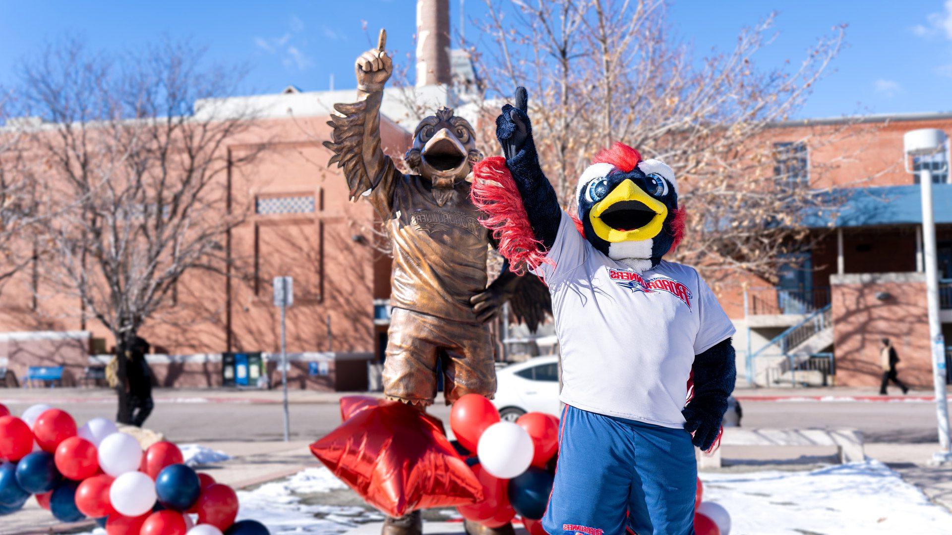 Rowdy the mascot standing in front of the Rowdy Statue during the statue unveiling in front of the Tivoli in January 2024.