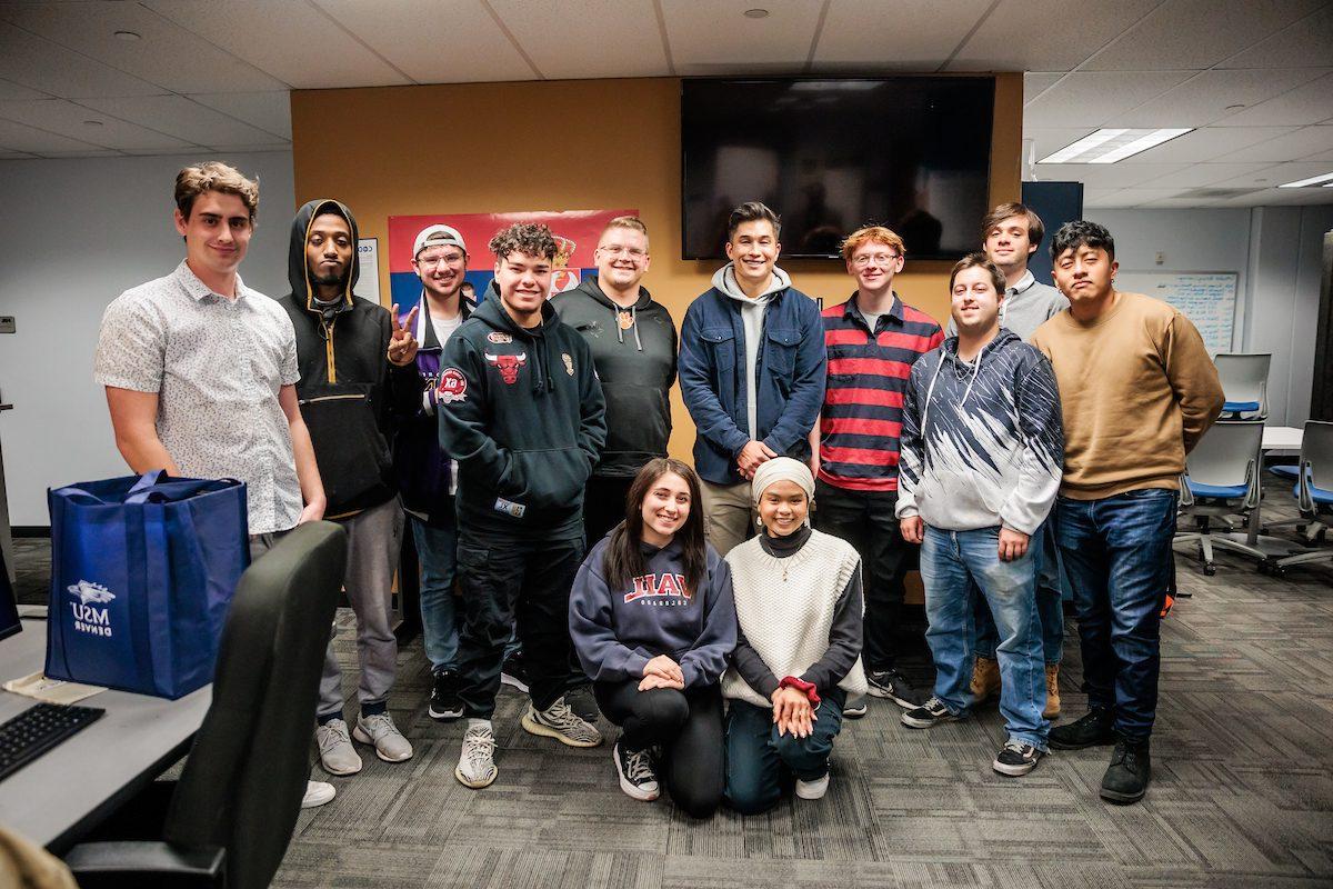 MSU Denver Alum and ESPN anchor, Gary Striewski, C, Poses for a photo with journalism students