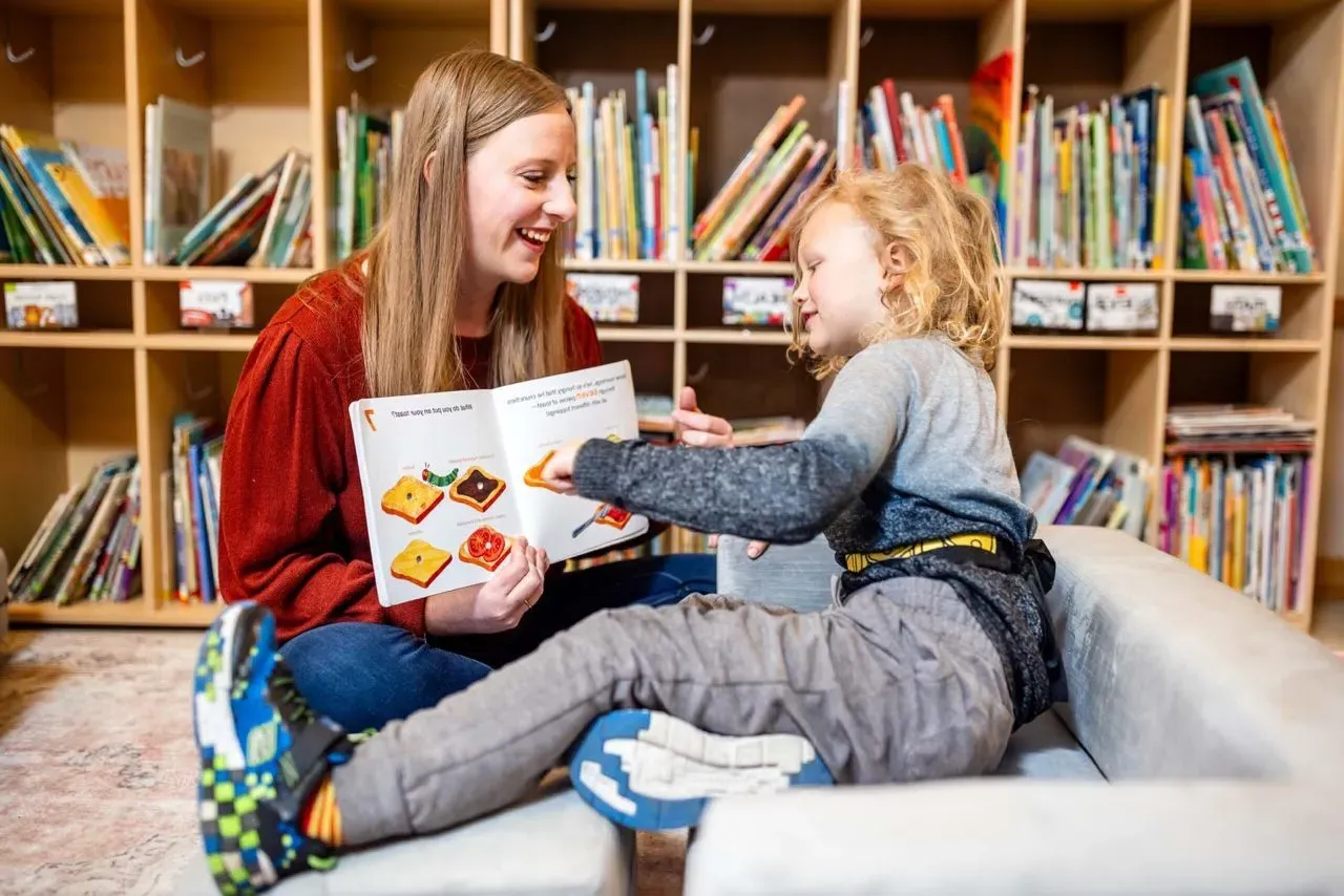 MSU Denver’s Abby Marroon works on articulation with Monty Manley, 4, while reading a book at the Auraria Early Learning Center.